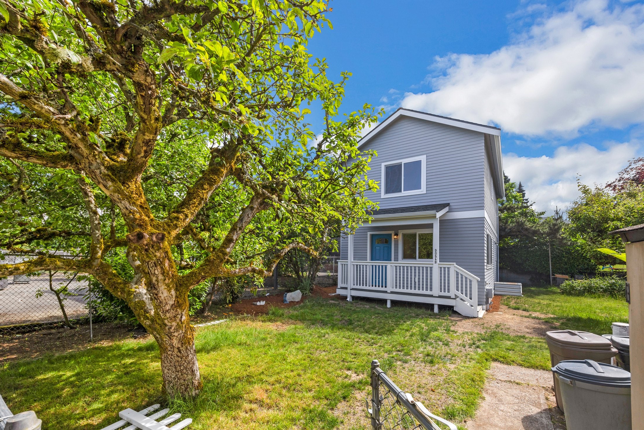 Detached ADU built by DIGS Construction sharing a Seattle-area backyard with a mature tree