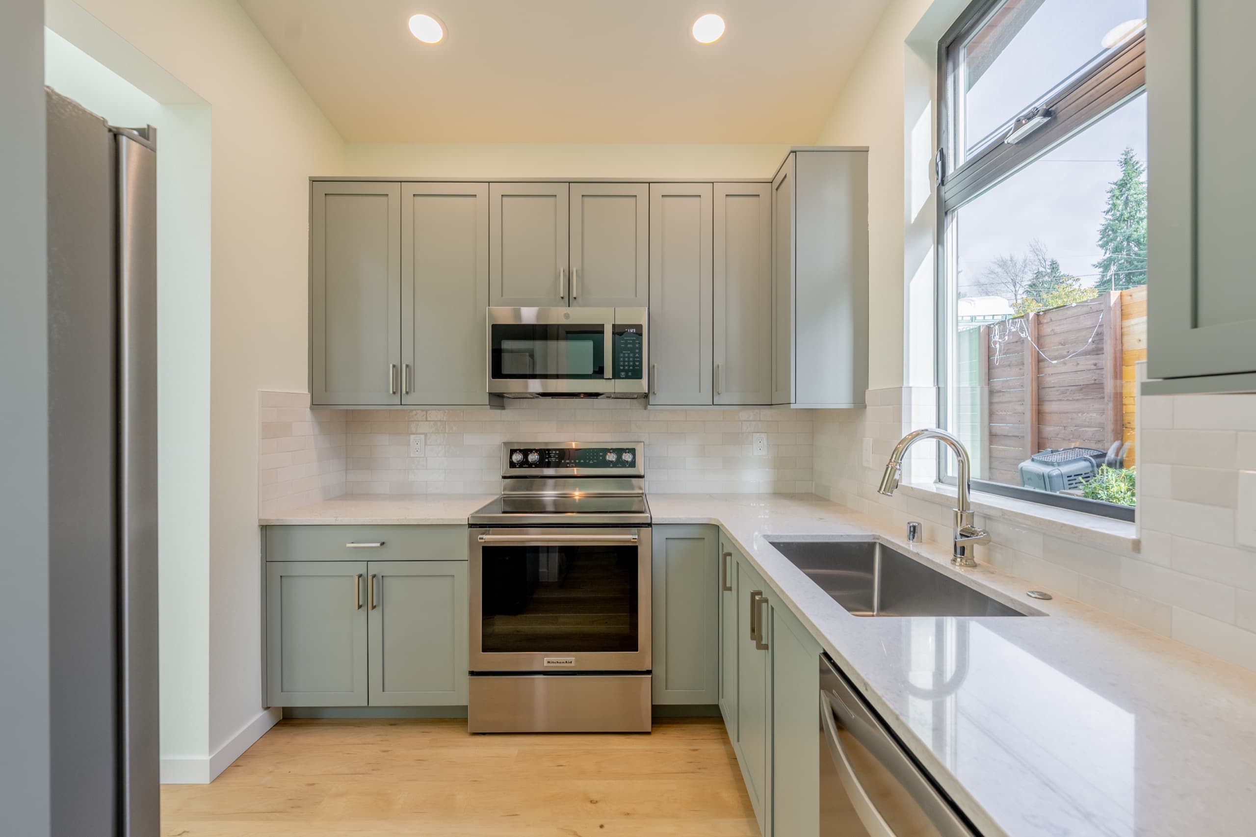 Finished kitchen with custom cabinetry inside a completed DIGS Construction detached accessory dwelling unit