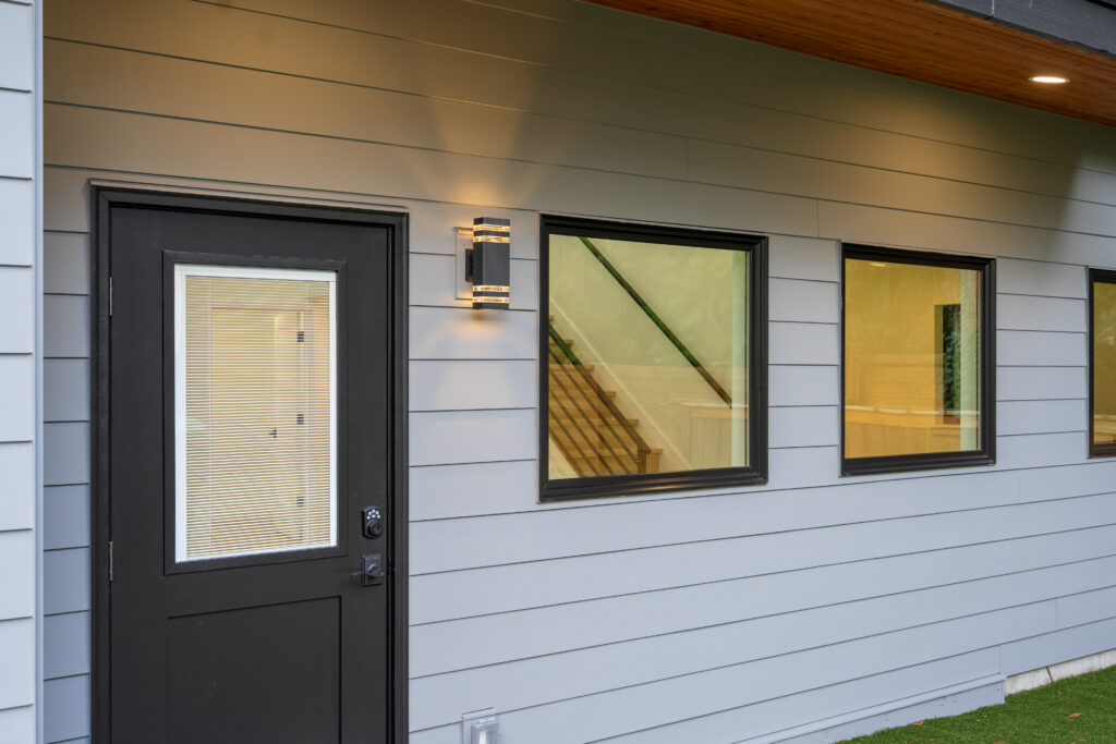 exterior entry door windows siding sconce light
